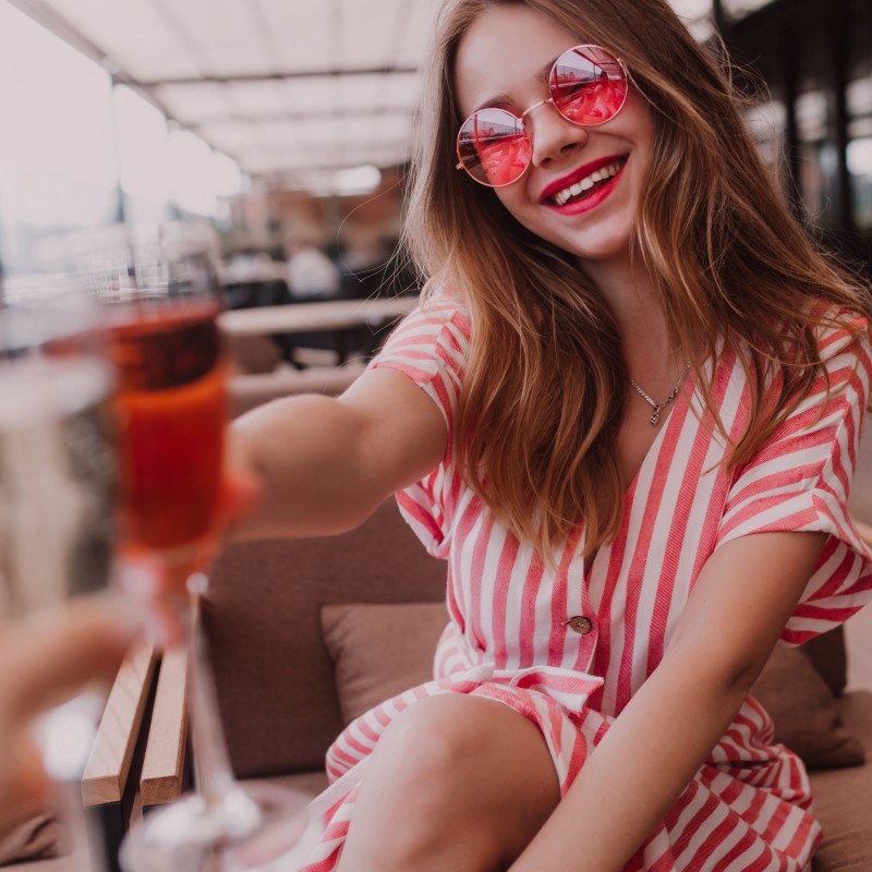 Girl drinks a glass of Ducoeur natural rosé.